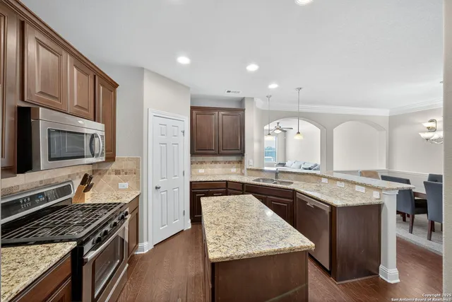 a kitchen with stainless steel appliances granite countertop counter space a stove and cabinets