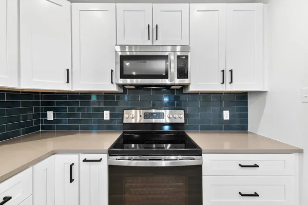 a stove top oven sitting inside of a kitchen