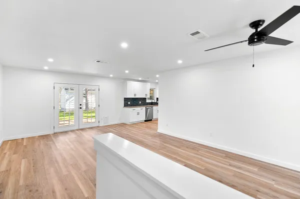 a view of an empty room and a window