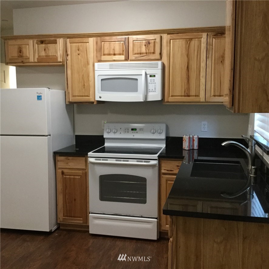 4606 Wood Place Everett, WA 98203 - Photo 15 of 37 a kitchen with a stove and a microwave