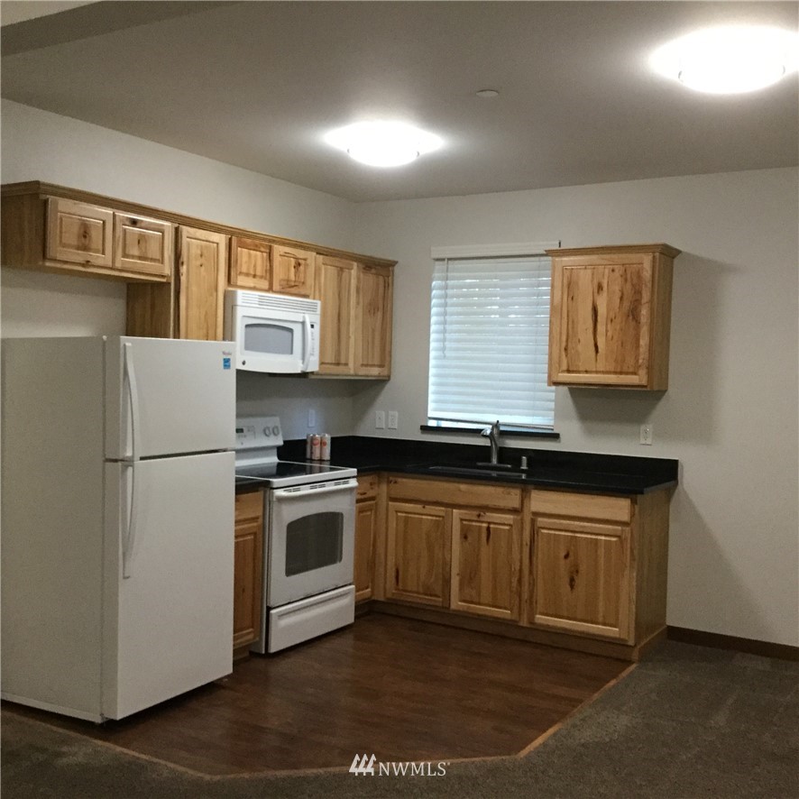 4606 Wood Place Everett, WA 98203 - Photo 16 of 37 a kitchen with stainless steel appliances granite countertop a stove a sink and a refrigerator