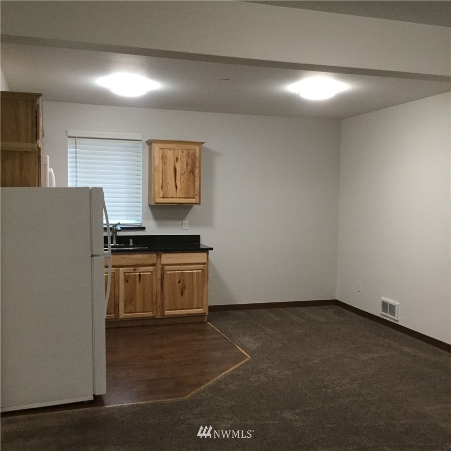 4606 Wood Place Everett, WA 98203 - Photo 17 of 37 a kitchen with granite countertop a sink and cabinets