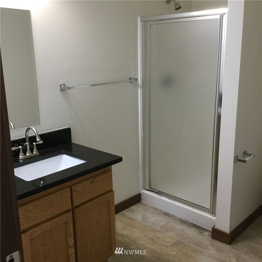 4606 Wood Place Everett, WA 98203 - Photo 22 of 37 a bathroom with a sink and a mirror