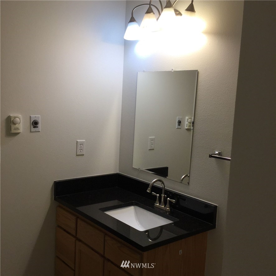 4606 Wood Place Everett, WA 98203 - Photo 27 of 37 a bathroom with a sink and a mirror