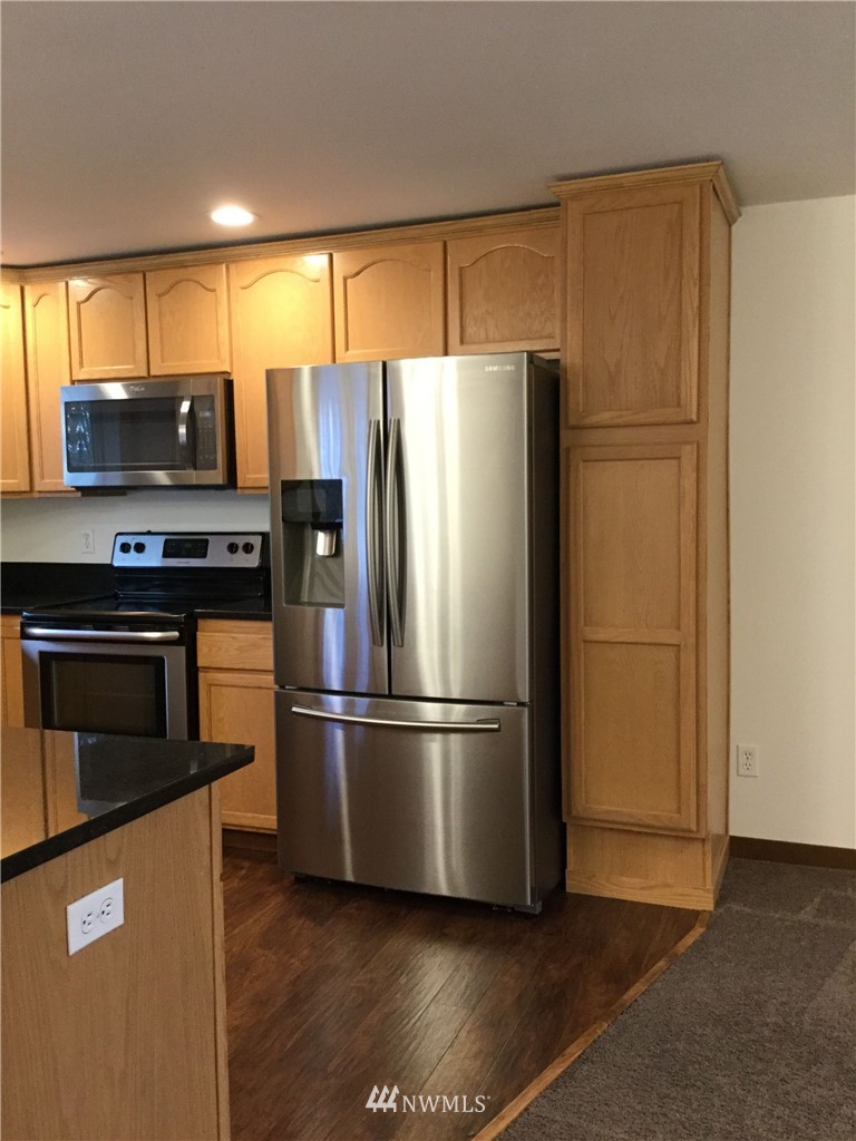4606 Wood Place Everett, WA 98203 - Photo 6 of 37 a metallic refrigerator freezer sitting in a kitchen