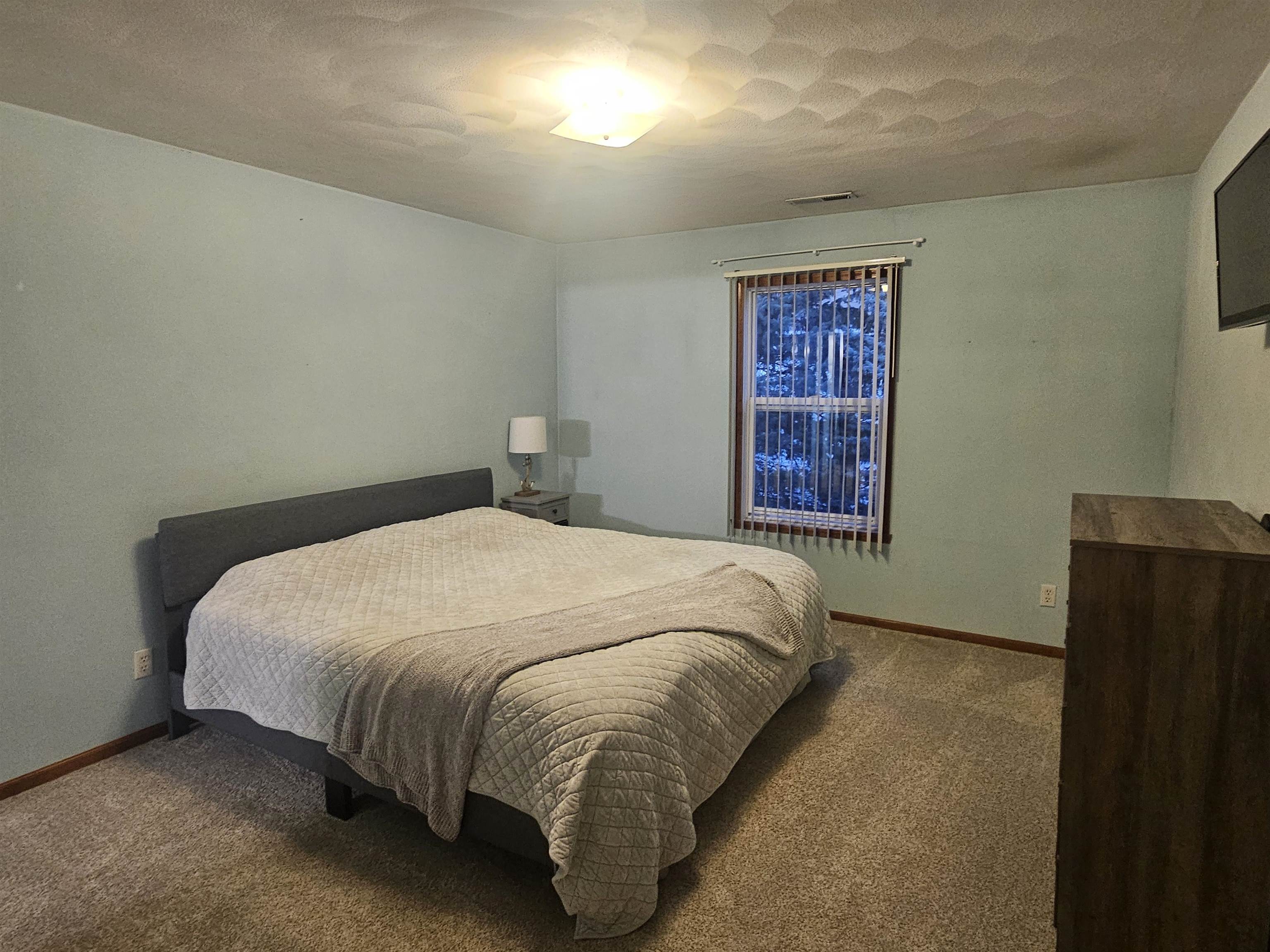 10167 Monarch Road Roscoe, IL 61073 - Photo 11 of 23 a bed sitting in a bedroom next to a window