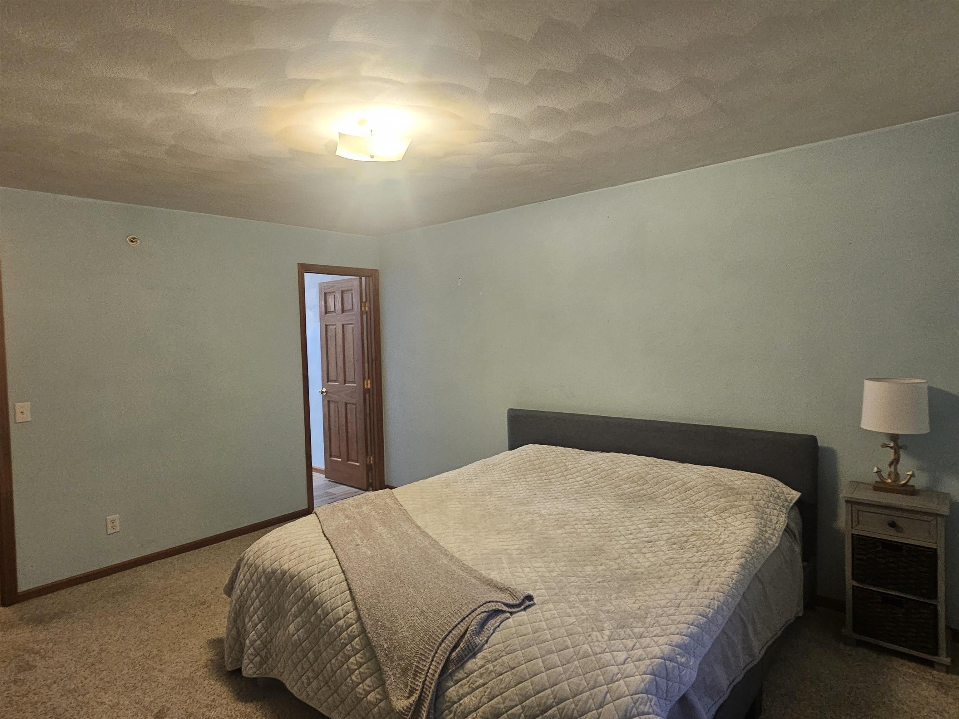 10167 Monarch Road Roscoe, IL 61073 - Photo 12 of 23 a bedroom with a bed and chair