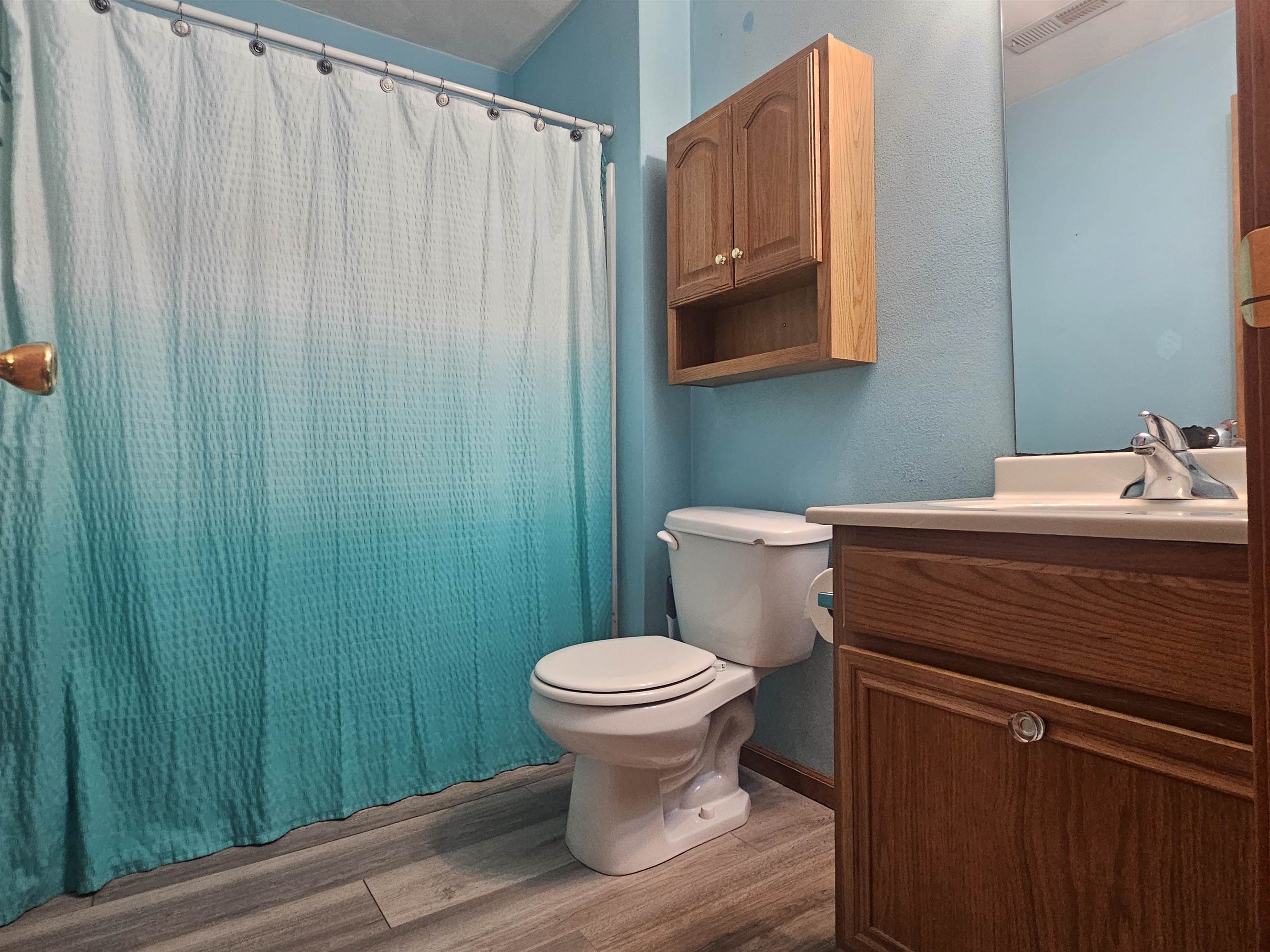 10167 Monarch Road Roscoe, IL 61073 - Photo 18 of 23 a bathroom with a granite countertop toilet and a sink