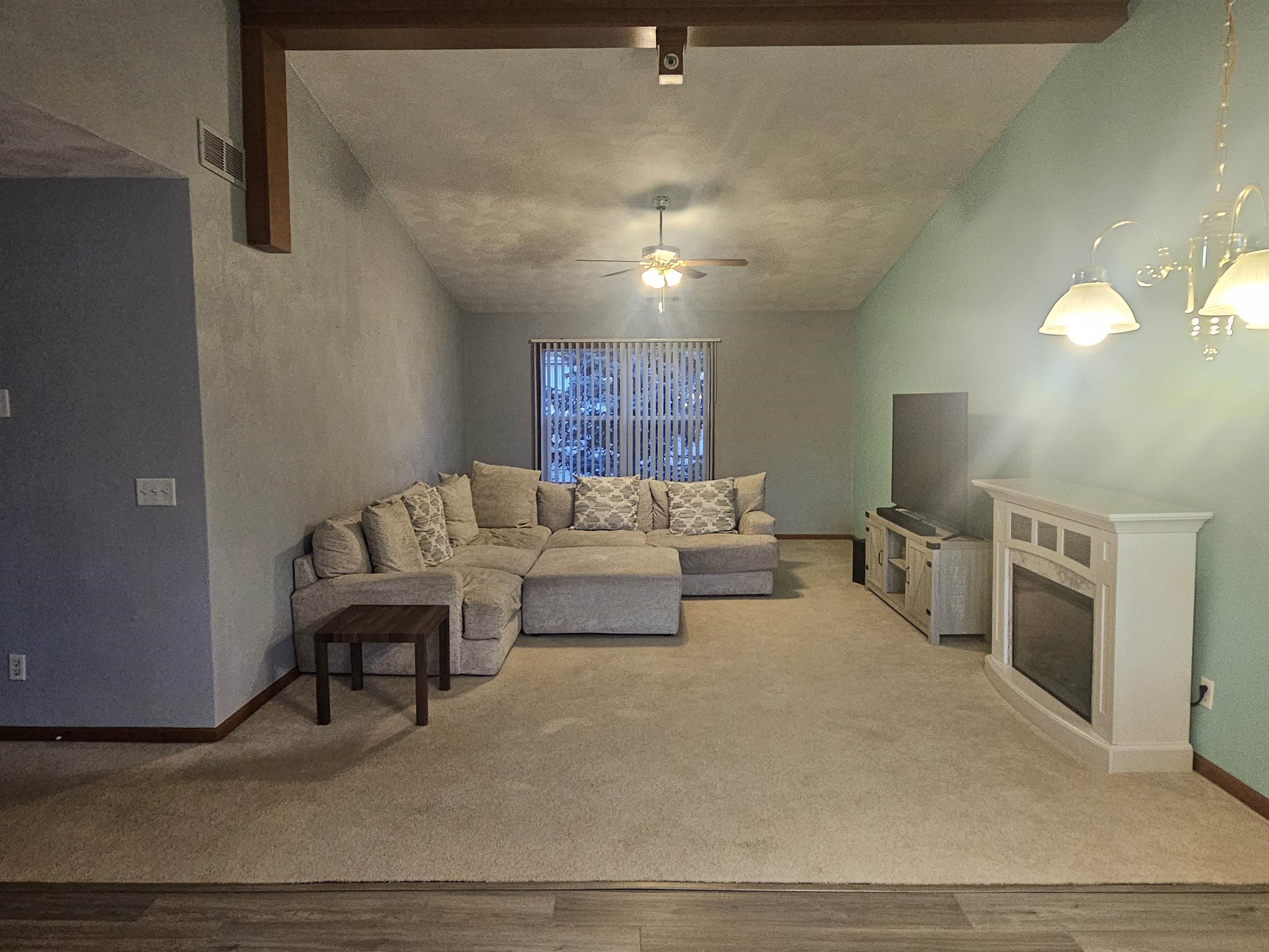 10167 Monarch Road Roscoe, IL 61073 - Photo 7 of 23 a living room with furniture and a chandelier