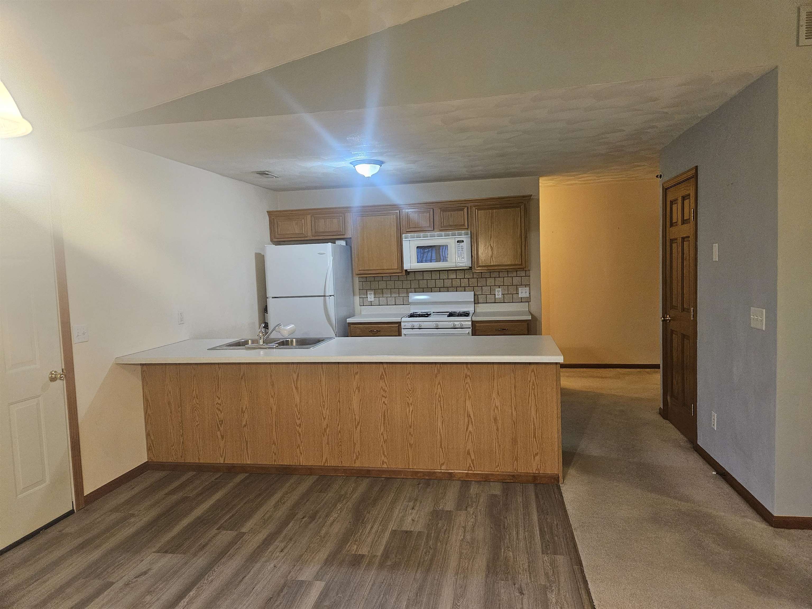 10167 Monarch Road Roscoe, IL 61073 - Photo 8 of 23 a kitchen with stainless steel appliances granite countertop a stove a refrigerator and a microwave