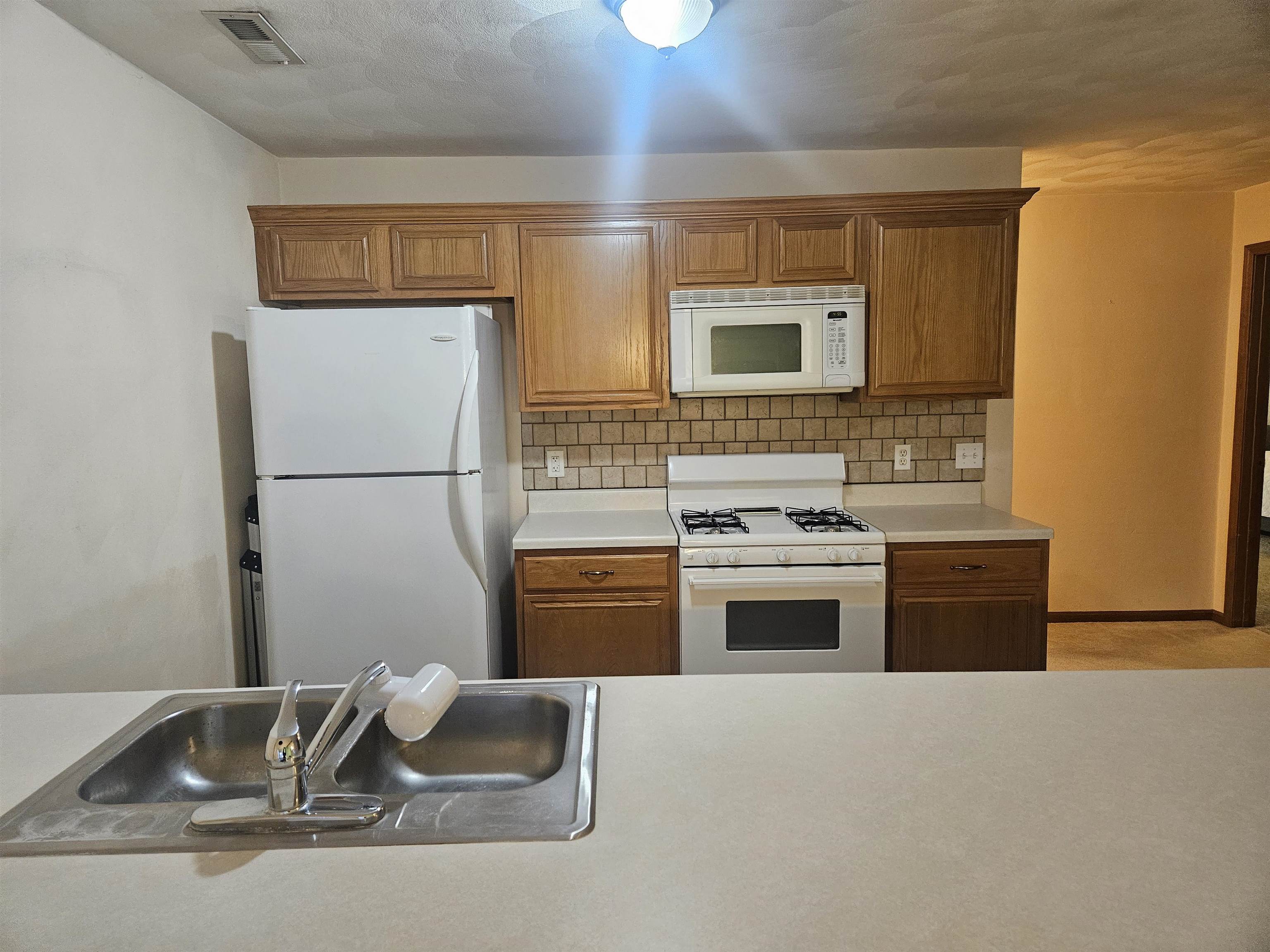 10167 Monarch Road Roscoe, IL 61073 - Photo 9 of 23 a kitchen with stainless steel appliances granite countertop a sink stove and refrigerator
