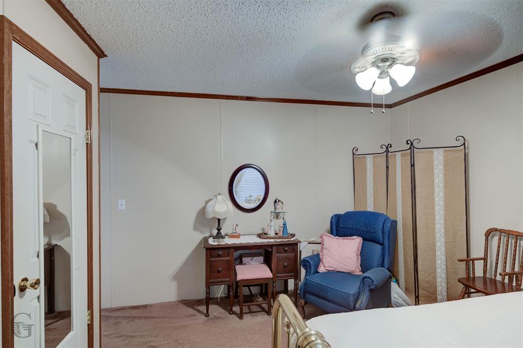 8839 Sebastian Road Keithville, LA 71047 - Photo 15 of 40 Paneled walls with wood-finish trim, textured ceiling, and a ceiling fan with light fixture