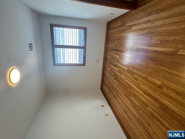 28 Rome Street Newark, NJ 07105 - Photo 2 of 8 an empty room with wooden floor and windows