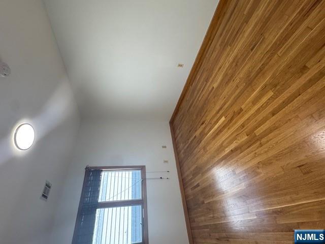 28 Rome Street Newark, NJ 07105 - Photo 3 of 8 an empty room with wooden floor and windows