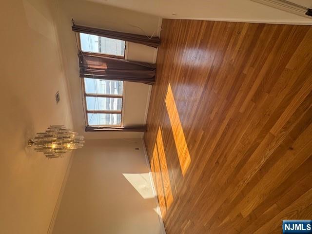 28 Rome Street Newark, NJ 07105 - Photo 4 of 8 a view of empty room with window and wooden floor