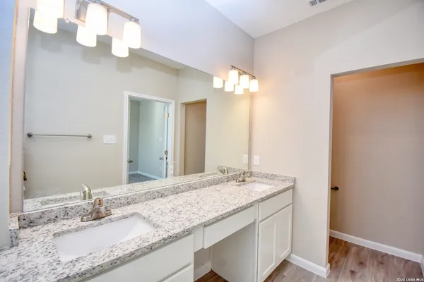 a bathroom with a granite countertop sink mirror and double