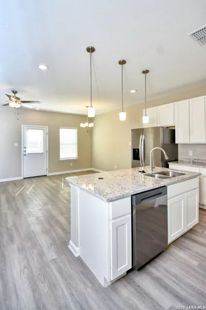 a view of a kitchen with a sink and cabinet