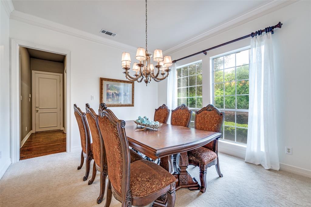 2841 Winding Creek Road Prosper, TX 75078 - Photo 17 of 40 a dining room with furniture a chandelier and wooden floor