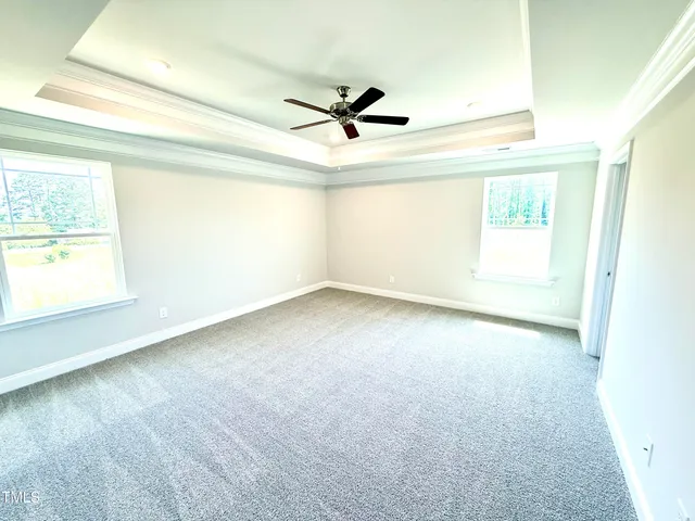 a view of a livingroom with a ceiling fan and window