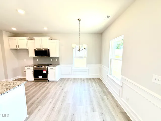 a kitchen with sink refrigerator and microwave