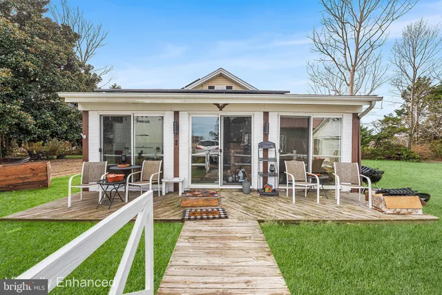 a view of a house with a yard patio and a garden