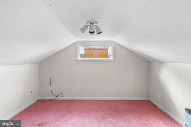 an empty room with windows and cabinet