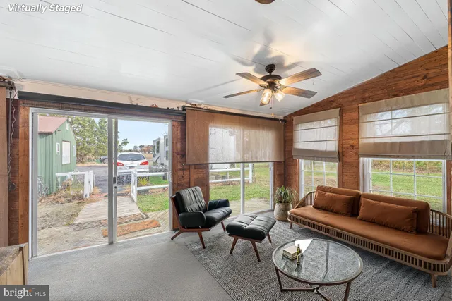 a living room with furniture and a large window with outer view