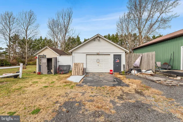 a view of a house with a yard and wooden fence