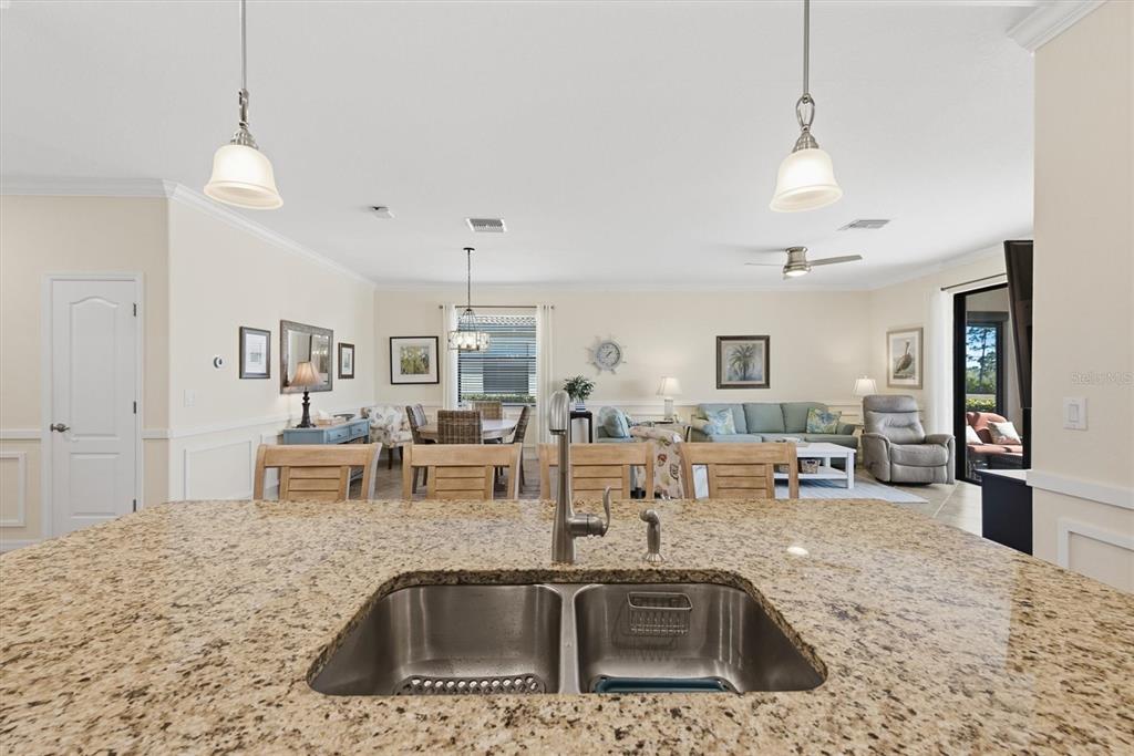 10475 Medjool Drive Venice, FL 34293 - Photo 20 of 71 a kitchen with stainless steel appliances granite countertop a sink a stove and a wooden floors