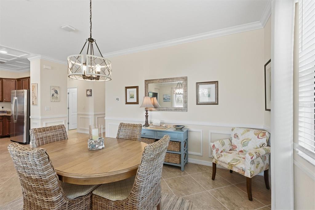 10475 Medjool Drive Venice, FL 34293 - Photo 24 of 71 a view of a dining room with furniture and chandelier