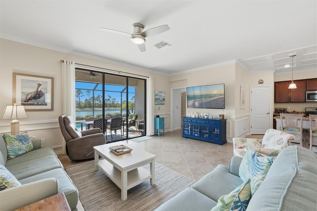 10475 Medjool Drive Venice, FL 34293 - Photo 25 of 71 a living room with furniture and a flat screen tv
