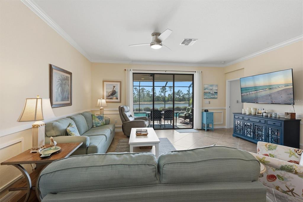 10475 Medjool Drive Venice, FL 34293 - Photo 27 of 71 a living room with furniture and a flat screen tv