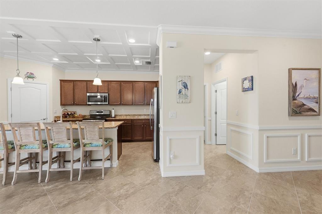 10475 Medjool Drive Venice, FL 34293 - Photo 29 of 71 a kitchen with kitchen island white cabinets and stainless steel appliances
