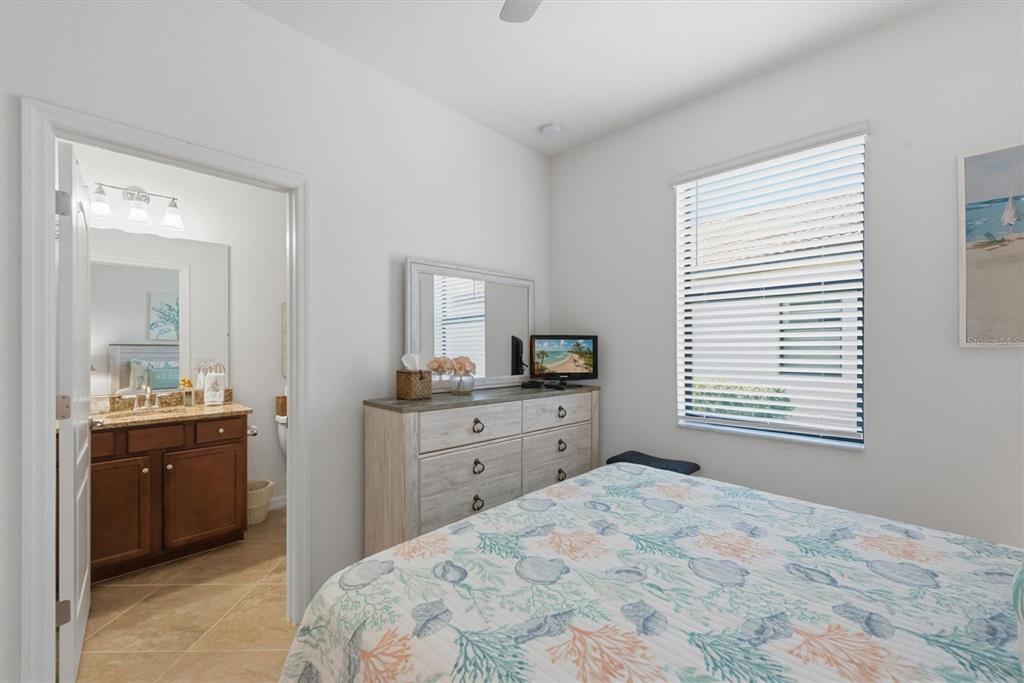 10475 Medjool Drive Venice, FL 34293 - Photo 35 of 71 a bedroom with a bed and a dresser