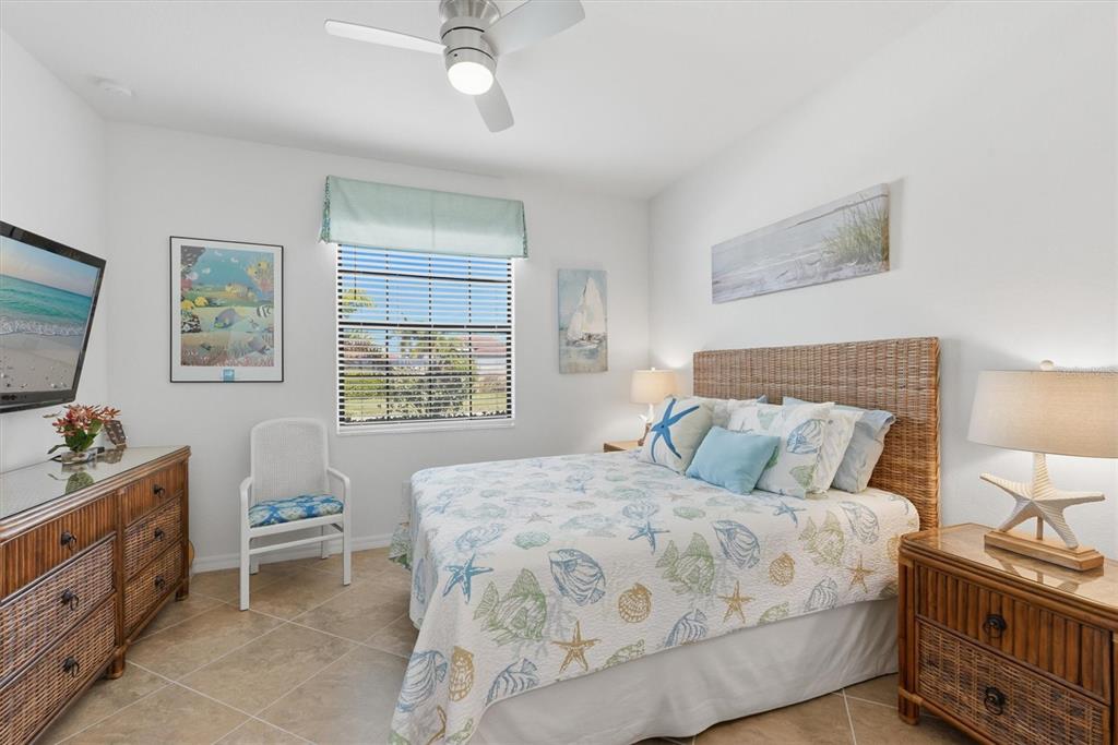 10475 Medjool Drive Venice, FL 34293 - Photo 41 of 71 a bedroom with a bed and a dresser in it