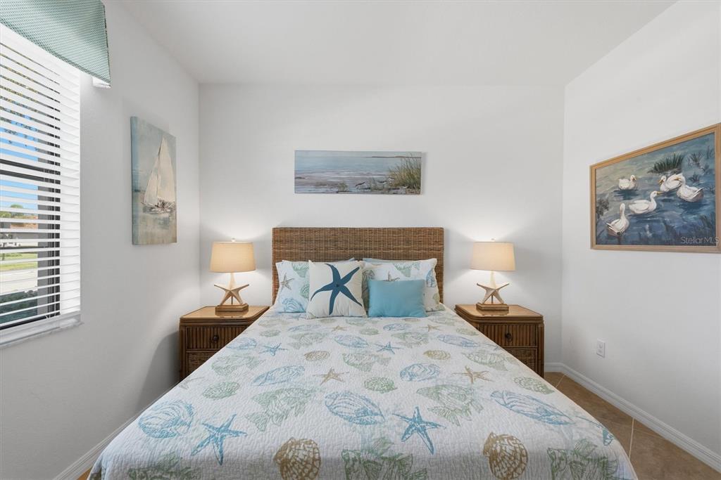 10475 Medjool Drive Venice, FL 34293 - Photo 42 of 71 a bedroom with a bed and a night stand