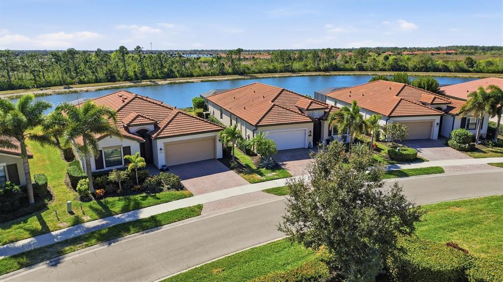 10475 Medjool Drive Venice, FL 34293 - Photo 62 of 71 an aerial view of a house with a garden and lake view