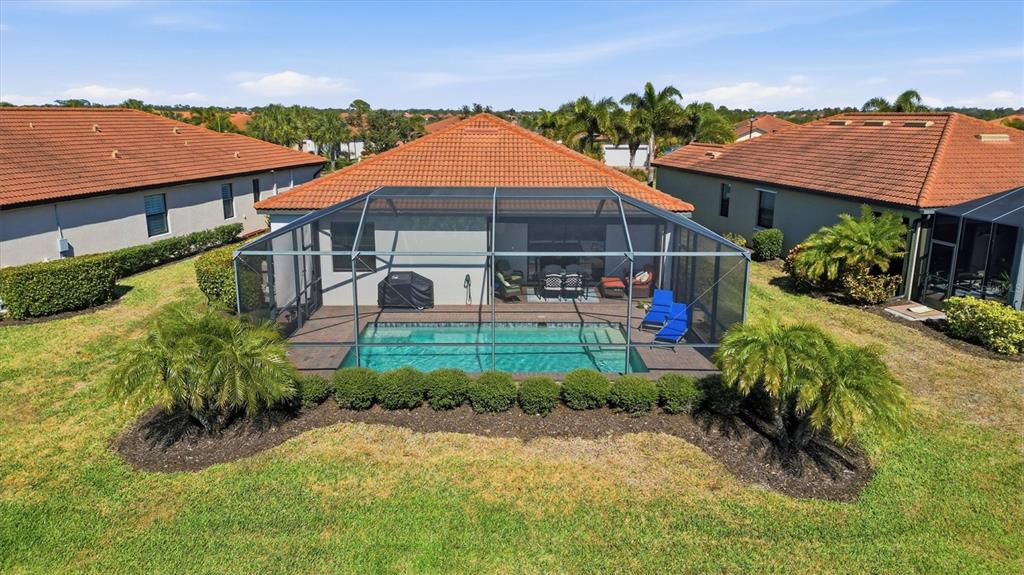 10475 Medjool Drive Venice, FL 34293 - Photo 66 of 71 a view of a house with a yard and potted plants