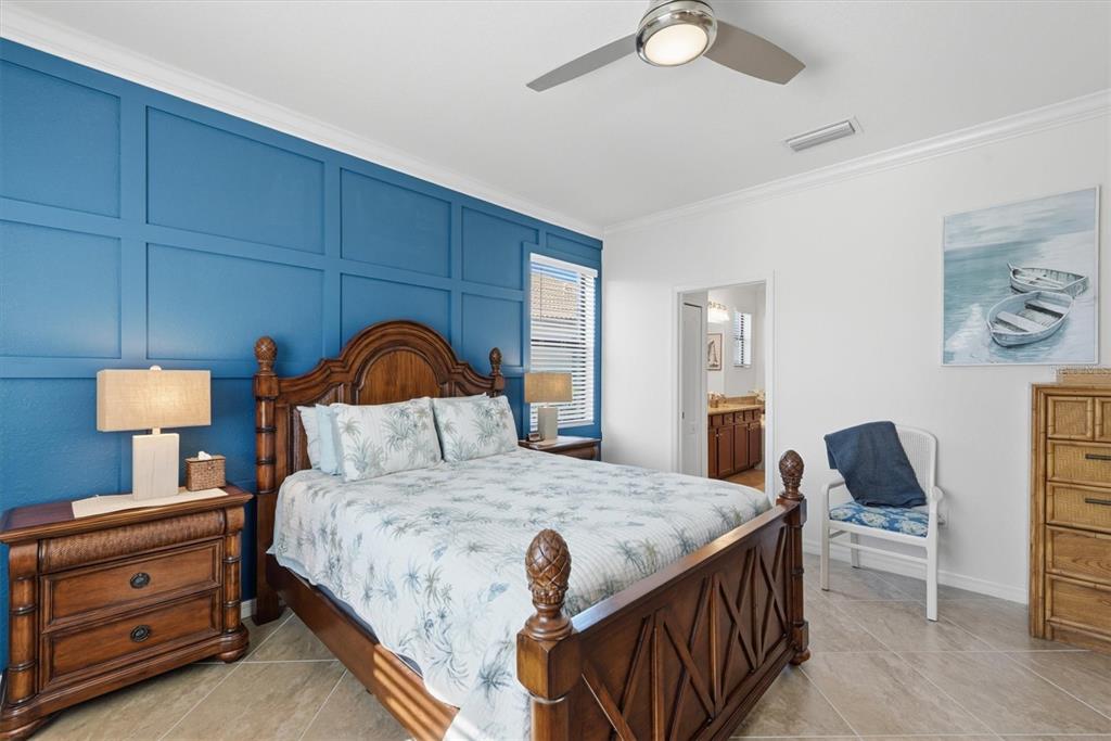 10475 Medjool Drive Venice, FL 34293 - Photo 7 of 71 a bedroom with a bed and a lamp on dresser