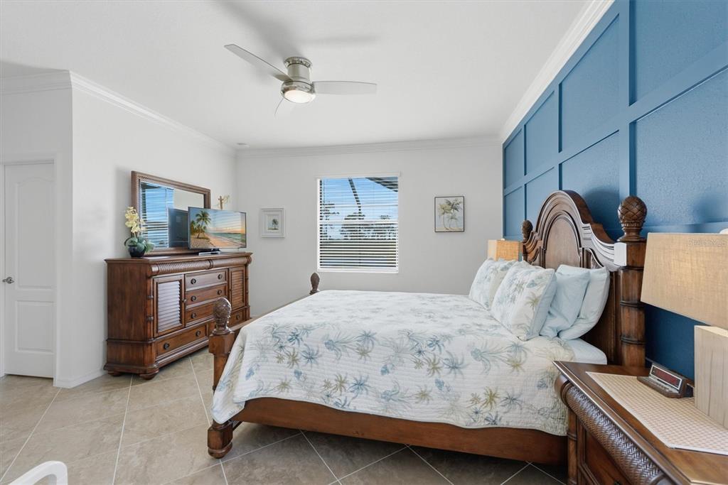 10475 Medjool Drive Venice, FL 34293 - Photo 8 of 71 a bedroom with a bed and a dresser in it