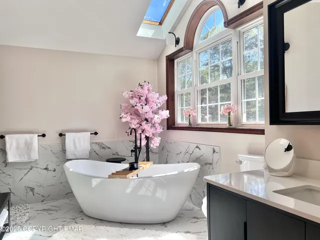a white bath tub sitting next to a bathroom sink