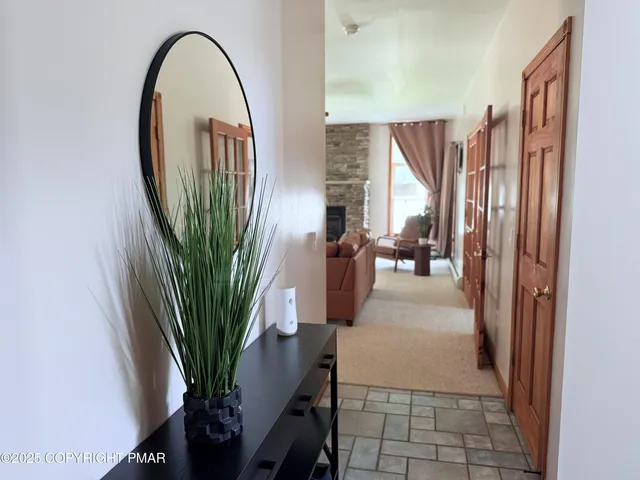 a view of entryway and hall with wooden floor