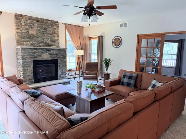 a living room with furniture kitchen view and a fireplace