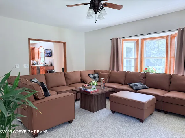 a living room with furniture and a large window