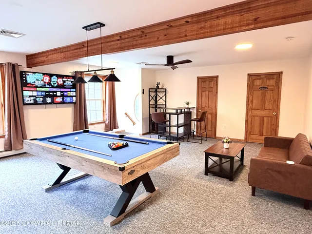 a living room with furniture pool table and a table