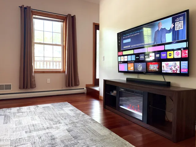 a view of an entryway with wooden floor