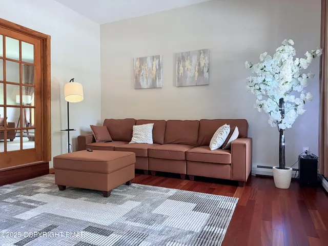 a living room with furniture and a chandelier