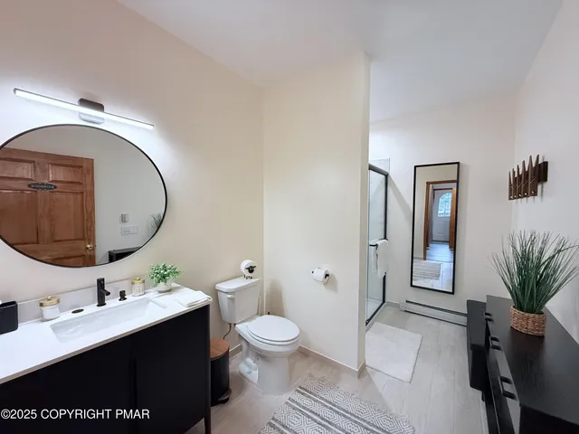 a bathroom with a toilet a sink and mirror