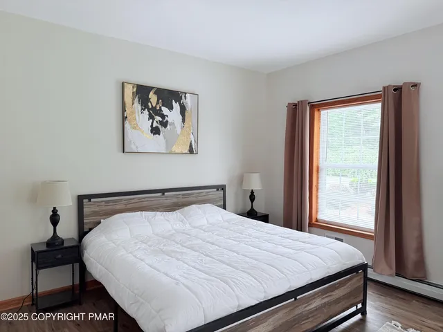 a large bed sitting in a bedroom next to a window
