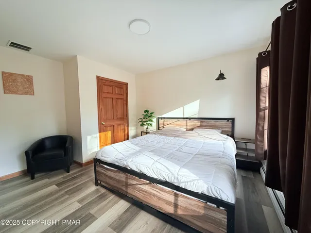 a bedroom with a bed and a dresser